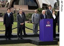 APEC leaders stand behind Australian Prime Minister John Howard as he delivers the APEC final declaration at the close of their weekend summit in Sydney, Australia, Sunday, 09 Sept. 2007