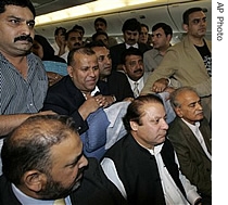 Former Pakistani Prime Minister Nawaz Sharif, bottom center, surrounded by aides and supporters on an ariplane as he arrives in Islamabad, Pakistan after he flew from London, England, 10 Sep 2007