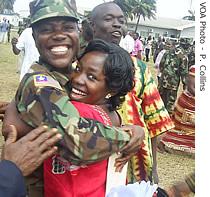 Liberian soldier celebrates with family at the graduation ceremony