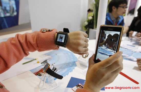 A staff member shows an electronic product, which can be connected with mobile phones with bluetooth technology, during the 2nd China (Shanghai) International Technology Fair in Shanghai, east China, April 24, 2014. The fair kicked off here Thursday. (Xinhua/Fang Zhe) 