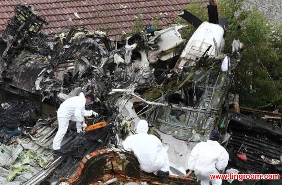 Investigators work at the accident site after a Taiwan plane smashed into residential buildings following a failed emergency landing in the outlying island county of Penghu, southeast China