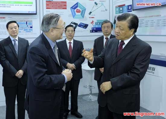 Liu Yunshan (R, front), a member of the Standing Committee of the Political Bureau of the Communist Party of China (CPC) Central Committee and secretary of the Secretariat of the CPC Central Committee, talks with a representative from China UnionPay as he visits an exhibition of network safety after the launching ceremony of the China Cybersecurity Week in Beijing, capital of China, Nov. 24, 2014. (Xinhua/Zhang Duo)