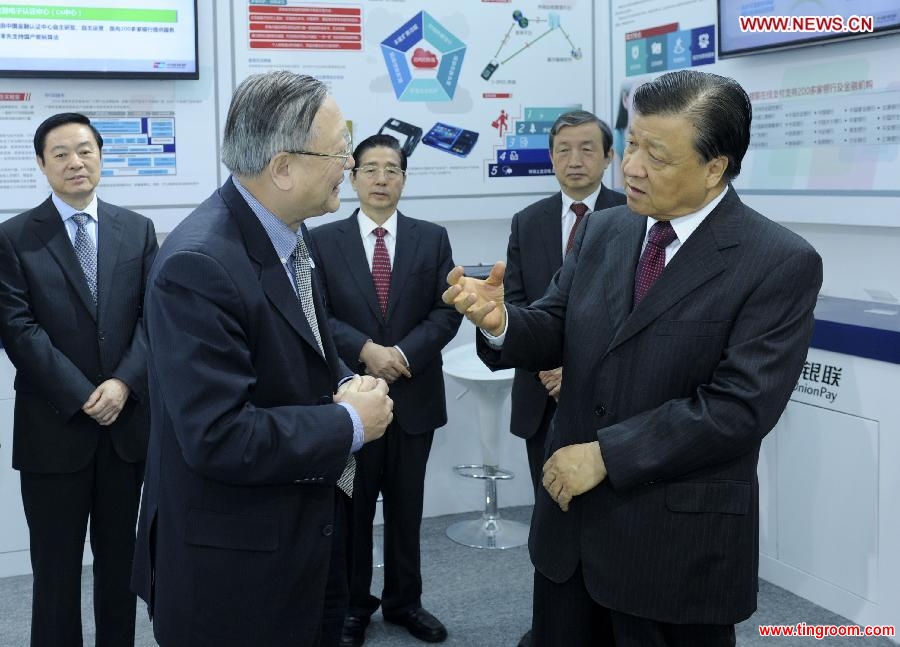 Liu Yunshan (R, front), a member of the Standing Committee of the Political Bureau of the Communist Party of China (CPC) Central Committee and secretary of the Secretariat of the CPC Central Committee, talks with a representative from China UnionPay as he visits an exhibition of network safety after the launching ceremony of the China Cybersecurity Week in Beijing, capital of China, Nov. 24, 2014. (Xinhua/Zhang Duo)