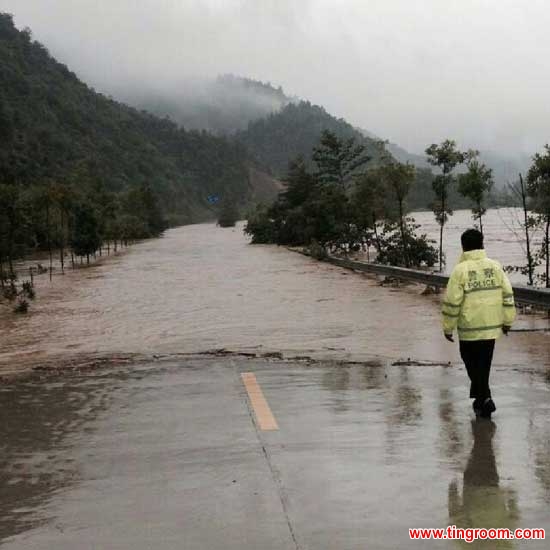 Photo taken with a cellphone shows a police officer checking a flooded road in Jiujiang, east China