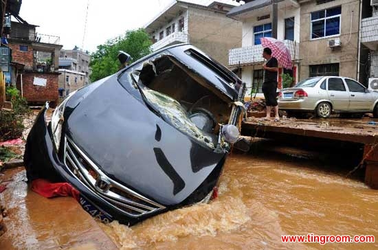 A car is carried into the riverway by flood in Yincheng Town of Dexing City, east China
