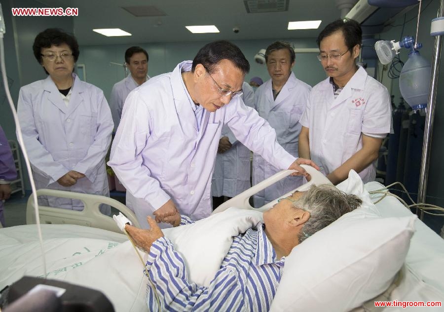 Chinese Premier Li Keqiang calls upon Zhu Hongmei, a 65-year-old survivor of the overturned ship, at a hospital in Jianli County, central China