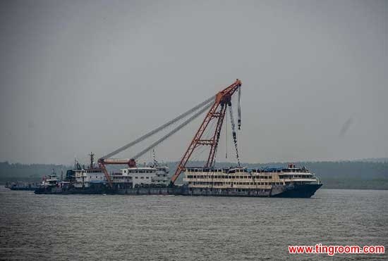 The capsized ship Eastern Star is towed away from the accident site in Jianli, central China