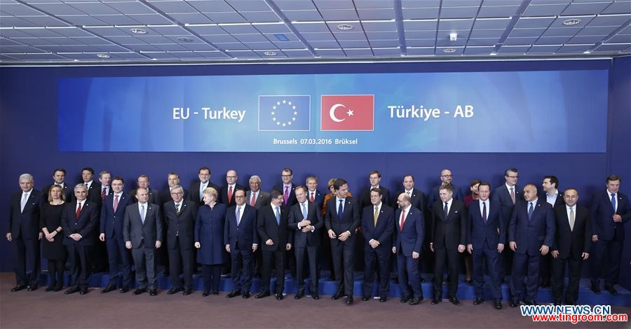 EU leaders and Turkish Prime Minister Ahmet Davutoglu gather for a group photo during an extraordinary summit of European Union leaders with Turkey at the European Council headquarters in Brussels, Belgium, March 7, 2016. (Xinhua/Ye Pingfan)