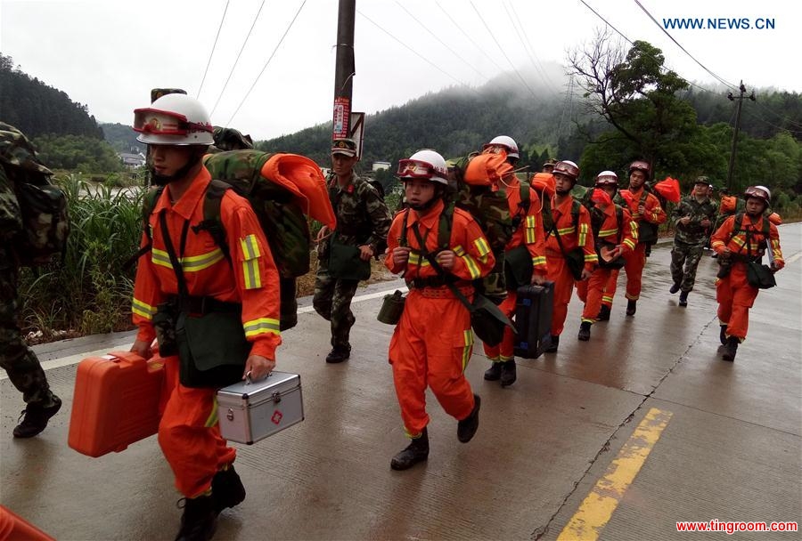SANMING, May 8, 2016 (Xinhua) -- Rescuers rush to the landslide site in Taining County, southeast China