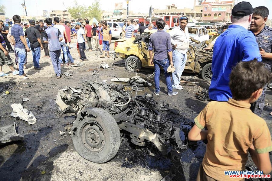  People gather at the explosion site after an attack killing around 16 people and wounding 53 others in Sadr City in eastern Baghdad, Iraq, on May 17, 2016. (Xinhua/Khalil Dawood) 