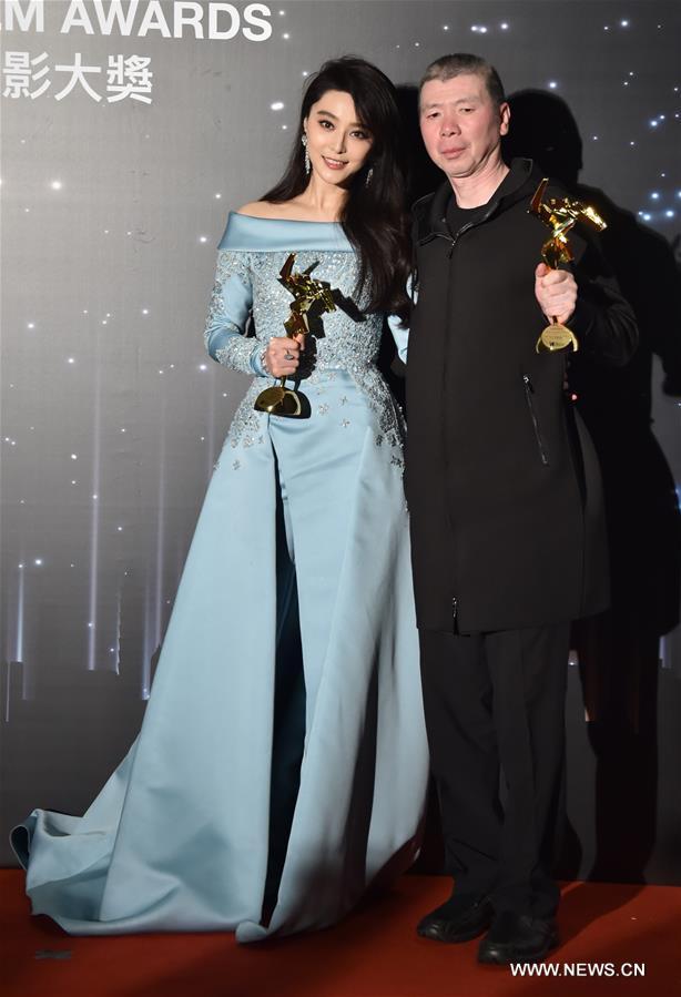 Chinese actress Fan Bingbing (L) and director Feng Xiaogang pose for photos during the presentation ceremony of the 11th Asian Film Awards in Hong Kong, south China, March 21, 2017. Fan Bingbing won the Best Actress Award for film "I am not Madame Bovary", and the film, directed by Feng Xiaogang, won the Best Film Award. (Xinhua/Lui Siu Wai) 