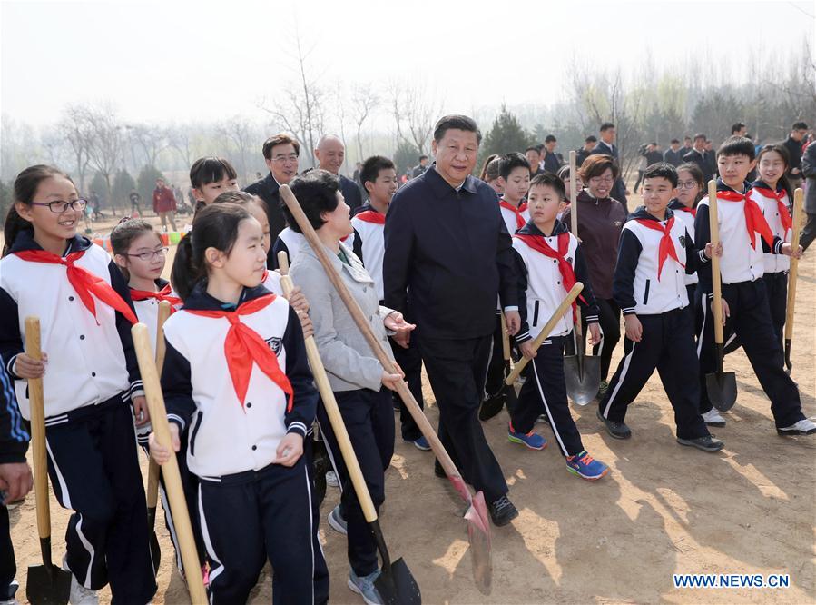 Chinese President Xi Jinping (C, front) walks with students as he attends a tree planting activity in Beijing, capital of China, March 29, 2017. China