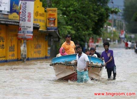 Villagers pull a boat with people after rescuing them, on a flooded road in Biyagama, Sri Lanka May 17, 2016. REUTERS/Dinuka LiyanawatteMore